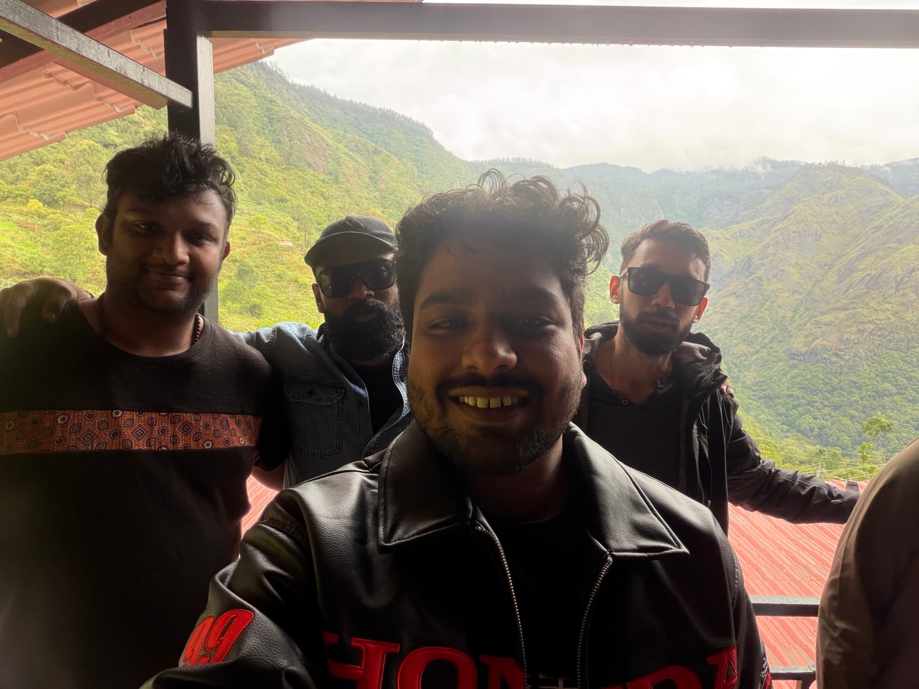 A group of travellers at a misty viewpoint