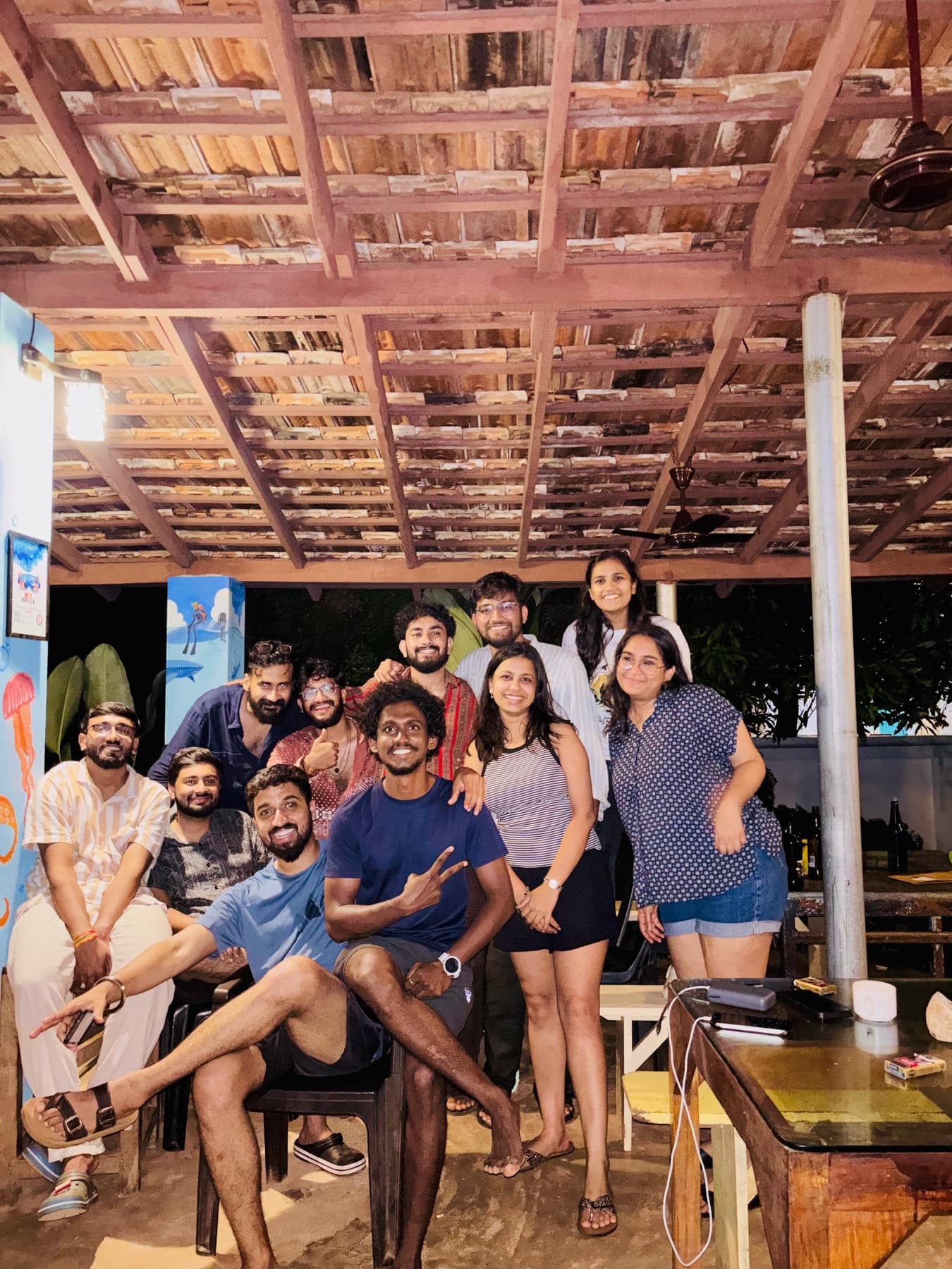 The crew at a beach shack, after dark